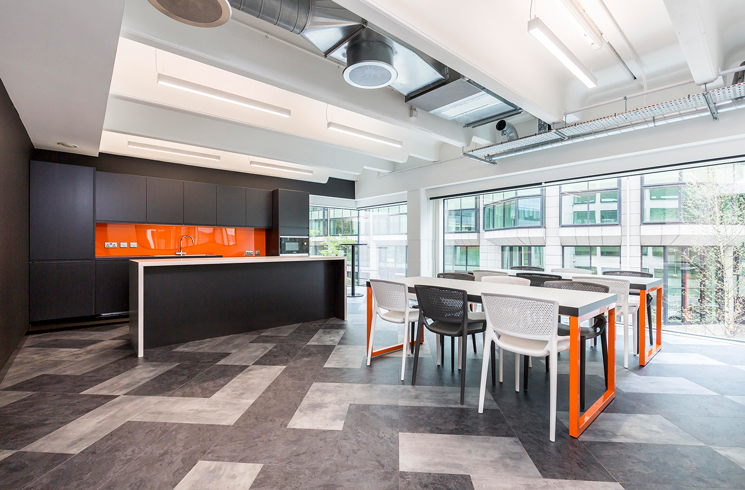 Company using orange and black its brand colours in breakout area.
