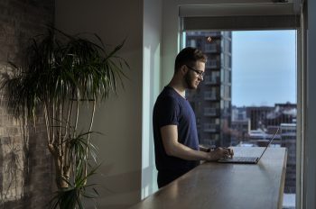 man standing at a laptop