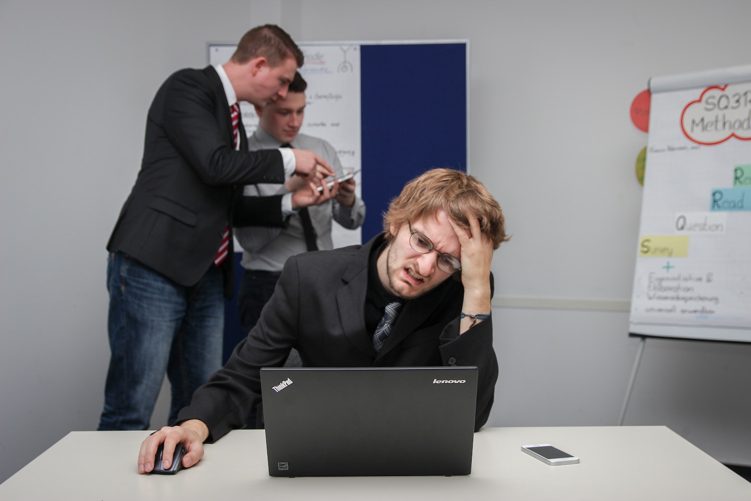 Man hands on head looking stressed in office